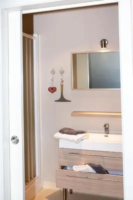 a bathroom with a sink and a mirror at Franciscushof in Pelt
