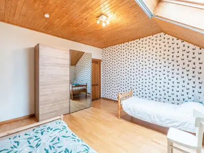 a bedroom with a bed and a table in a room at Zoutleeuw Home with Pool in Zoutleeuw