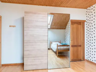 a sliding glass door in a bedroom with a bed at Zoutleeuw Home with Pool in Zoutleeuw
