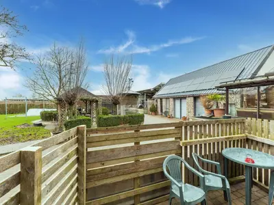 a wooden fence with a table and chairs on a patio at Zoutleeuw Home with Pool in Zoutleeuw