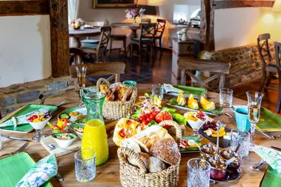 a table with food and baskets of food on it at La belle Maison in Sippenaeken