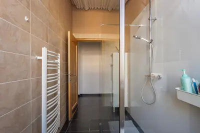 a bathroom with a shower and a walk in shower at Leopold Appartementen & studio's in Sint-Truiden