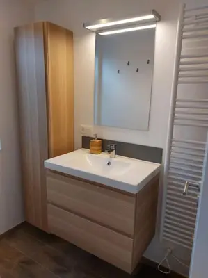 a bathroom with a white sink and a mirror at Aux six fontaines in Herve