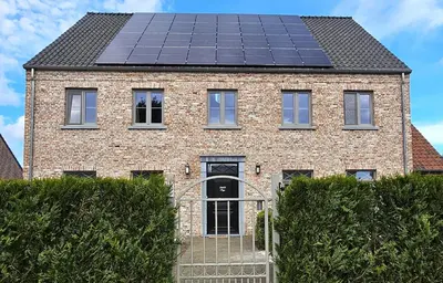 a house with solar panels on the roof at B&B Pippa in Peer