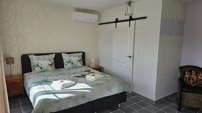 a bedroom with a bed with two towels on it at B&B Pippa in Peer