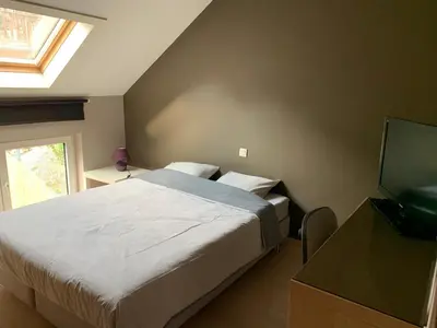 a bedroom with a bed and a flat screen tv at Fully furnished house, wifi, garage in Chaffours
