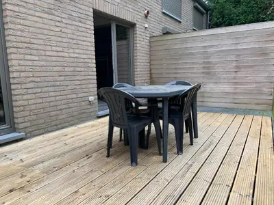 a black table and chairs on a wooden deck at Fully furnished house, wifi, garage in Chaffours