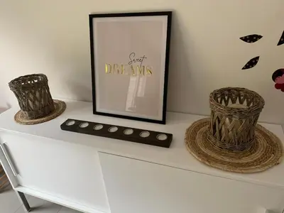 a white shelf with two baskets and a picture at Fully furnished house, wifi, garage in Chaffours