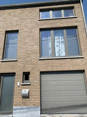 a brick building with two garage doors on it at Fully furnished house, wifi, garage in Chaffours