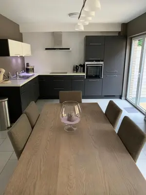 a kitchen and dining room with a wooden table and chairs at Fully furnished house, wifi, garage in Chaffours