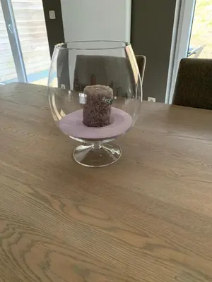 a teddy bear sitting in a wine glass on a table at Fully furnished house, wifi, garage in Chaffours