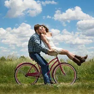 a man and a woman riding a bike at Huis van Loon in Borgloon