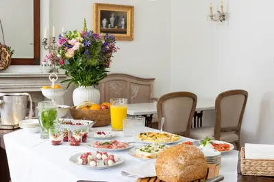 a breakfast table with food and drinks on it at Huis van Loon in Borgloon