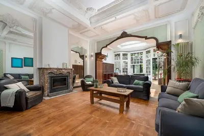 a living room with couches and a fireplace at Amazing appartement à Liège avec jardin in Liège