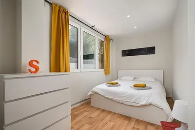 a small bedroom with a bed and a window at Amazing appartement à Liège avec jardin in Liège