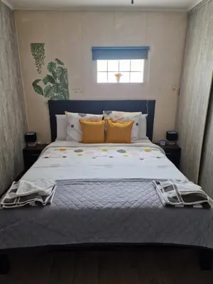 a bedroom with a large bed with yellow pillows at mignon in Soumagne