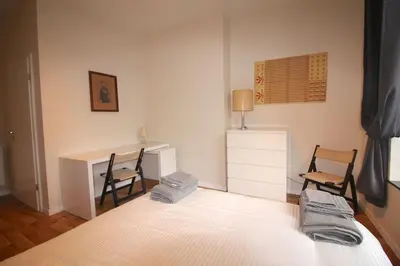 a bedroom with a desk and two chairs and a bed at Appartement 3 chambres en plein centre ville in Liège