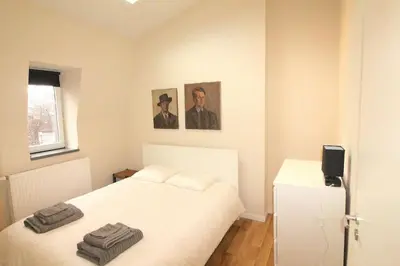 a bedroom with a white bed with two towels on it at Duplex de 3 chambres en plein centre ville - 82/3A in Liège