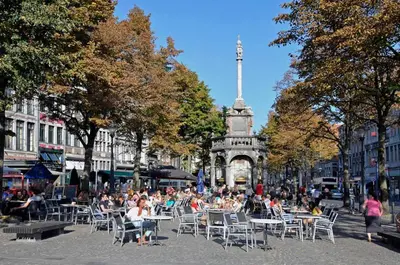 a group of people sitting at tables in a city at Appartement 021 in Liège