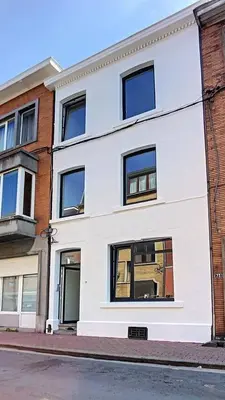 a white building on the side of a street at Appartement 021 in Liège