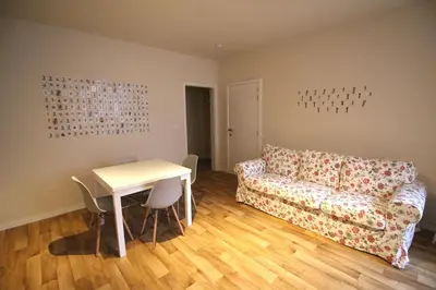 a living room with a couch and a table at Bel appartement 2 chambres avec terrasse in Liège