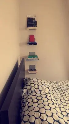 a bedroom with a bed and shelves on the wall at Appartement 4 chambres à Liège in Liège