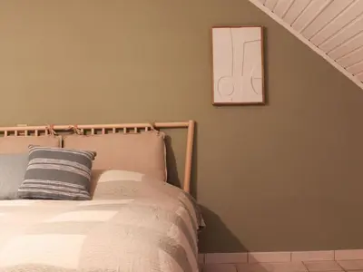a bedroom with a bed and a picture on the wall at Retreat near Maasmechelen in Lanaken