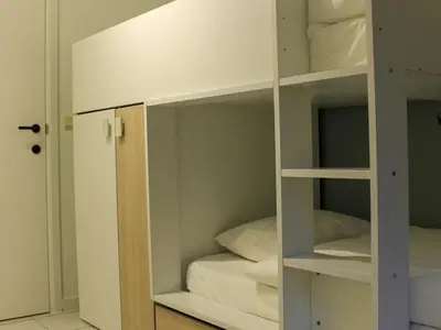a white bunk room with a bed in it at Retreat near Maasmechelen in Lanaken