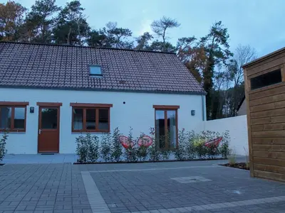 a white house with a brick driveway in front of it at Retreat near Maasmechelen in Lanaken