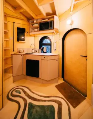a room with a kitchen with a sink and a door at Le pigeonnier - TinyHouse en plein centre de Liège in Liège