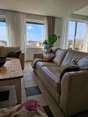 a living room with a couch and a table at Nimary Logies in Heusden - Zolder