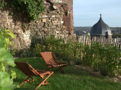 two chairs sitting in the grass next to a building at Bonjour Pierreuse in Liège