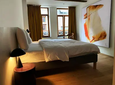 a bedroom with a bed and a window at Bonjour Pierreuse in Liège