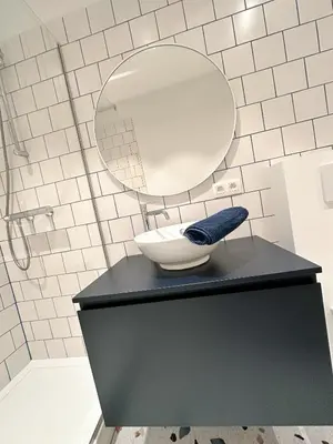 a bathroom with a sink and a mirror on a counter at Urbanchic Appart lumineux hyper centre in Liège