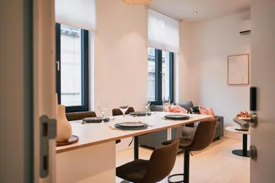a dining room with a table and chairs at Urbanchic Appart lumineux hyper centre in Liège