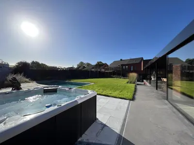 a hot tub in the backyard of a house at Bigaro II in Heers