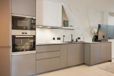 a kitchen with stainless steel appliances and white walls at Bos-Chalet bij Wijers Wandelroutes, Rust & Gezinsplezier Fijnspar 108 Hengelhoef in Houthalen-Helchteren