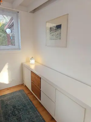 a white room with a dresser and a window at Molière in Rekem