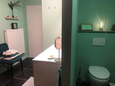 a bathroom with a toilet and a lamp on a counter at Casa Sandra Elisa in Maasmechelen