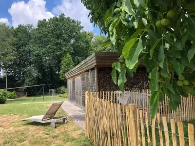 a chair sitting in a yard next to a fence at Casa Sandra Elisa in Maasmechelen
