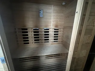 a walk in shower with wooden paneled walls and a wooden at Magnificent holiday home in Verviers with sauna in Verviers