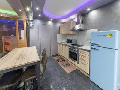 a kitchen with a white refrigerator and a table at Magnificent holiday home in Verviers with sauna in Verviers