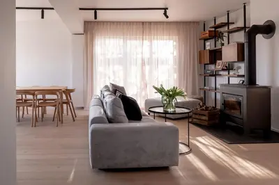 a living room with a couch and a table at MAM Haspengouw in Sint-Truiden