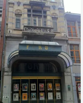 a front door of a building with a sign on it at Studio Montaigne in Liège