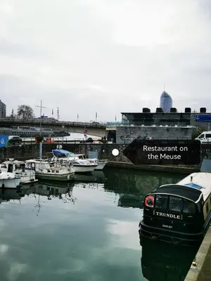 a boat parked next to a marina with boats in the water at Studio Montaigne in Liège