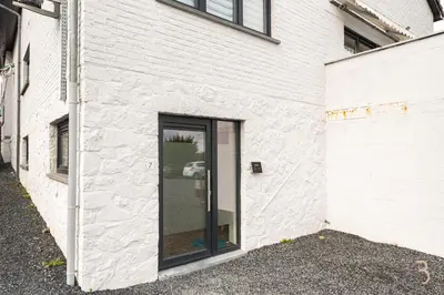 a white building with a sliding glass door at Smart Bnb - Appart Hotel Battice in Herve