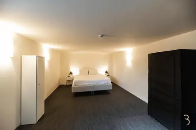 a bedroom with a bed and a tv in a room at Smart Bnb - Appart Hotel Battice in Herve