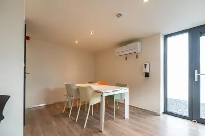 a dining room with a table and chairs at Smart Bnb - Appart Hotel Battice in Herve