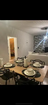 a dining room table with plates and glasses on it at Le cocon de la belle liégeoise in Liège