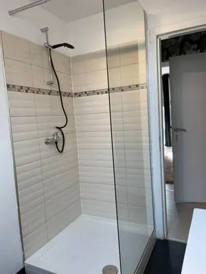 a shower with a glass door in a bathroom at Le cocon de la belle liégeoise in Liège